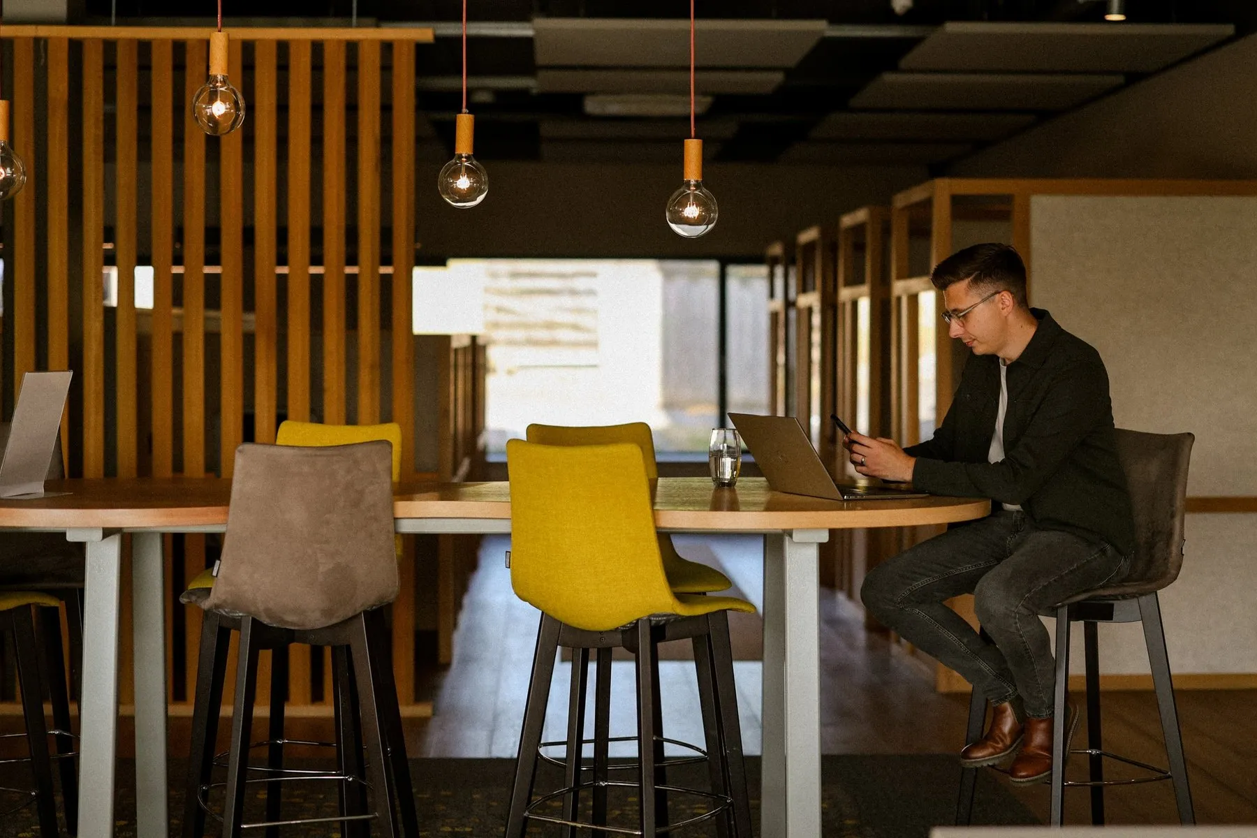 Ashton Lee Hudson working at a table in a bright office